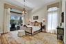 DESIGNER PRIMARY BEDROOM WITH MAHOGANY WOOD FLOORS UNDER RUG!