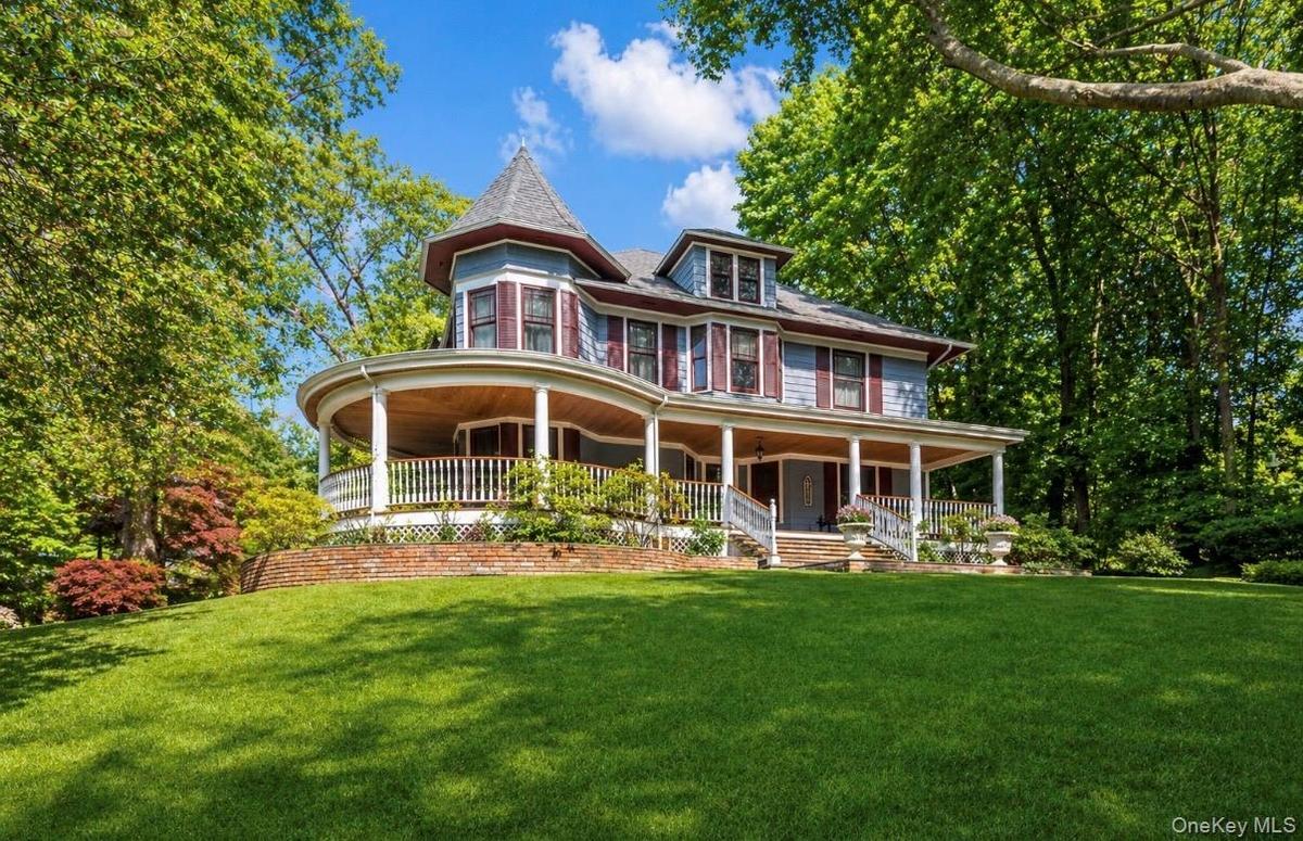 Victorian-style residence featuring a wraparound porch