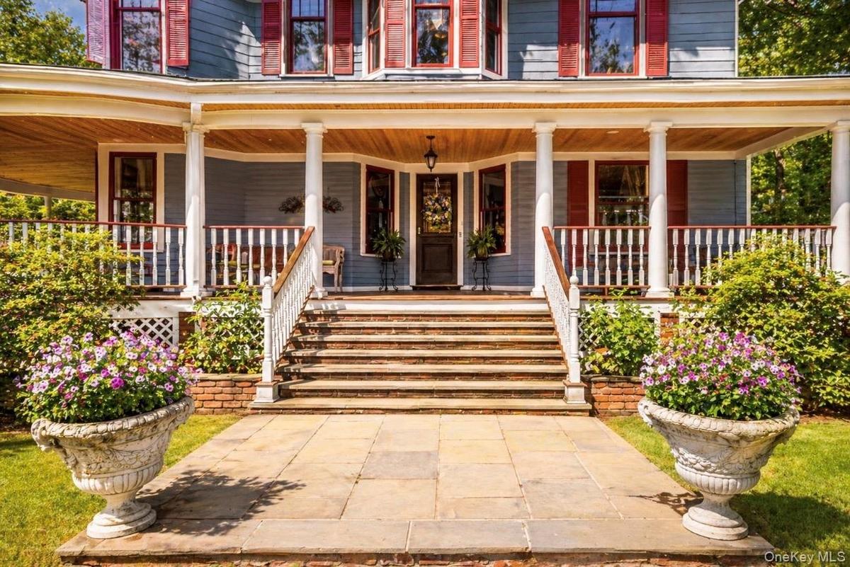 Doorway to property featuring wrap around porch