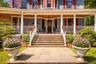 Doorway to property featuring wrap around porch