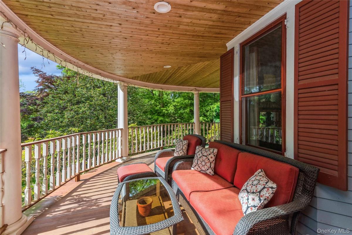 Wraparound, mahogany wood porch, featuring outdoor hangout area