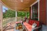 Wraparound, mahogany wood porch, featuring outdoor hangout area