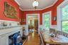 Breakfast room featuring hardwood flooring, white wainscoting, and a decorative fireplace