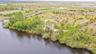 Lush native landscape offers opportunity for your private waterfront dream home!