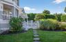 Manicured lawn with stepping stone pathway and white picket gate