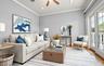 Bright living space featuring French doors, wood-finish flooring, crown molding, a ceiling fan, and recessed lighting