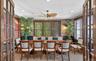 Spacious room featuring multiple large windows with horizontal blinds, decorative wall coverings, a ceiling fan, and recessed lighting