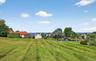 Expansive green lawn with distant water frontage