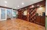 Built-in wine storage system with mahogany-toned cabinetry and integrated lighting