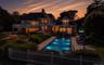 Exterior residence featuring multiple balconies and a large patio