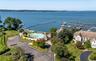 Waterfront property featuring a private marina, a freeform pool, and expansive green lawns