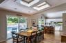 Vaulted ceilings featuring two skylights, recessed lighting, and wood-finish flooring