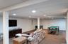 Finished basement recreation area featuring recessed lighting