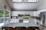 Kitchen featuring white cabinetry, stainless steel appliances, and a central island