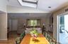 Open-concept interior featuring wood-finish flooring, a skylight, and recessed lighting