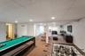 Spacious finished lower level featuring recessed lighting, paneled walls, and carpeted flooring