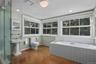 Large ensuite bathroom with soaking tub and shower