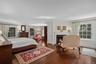 Primary bedroom with sitting area and fireplace