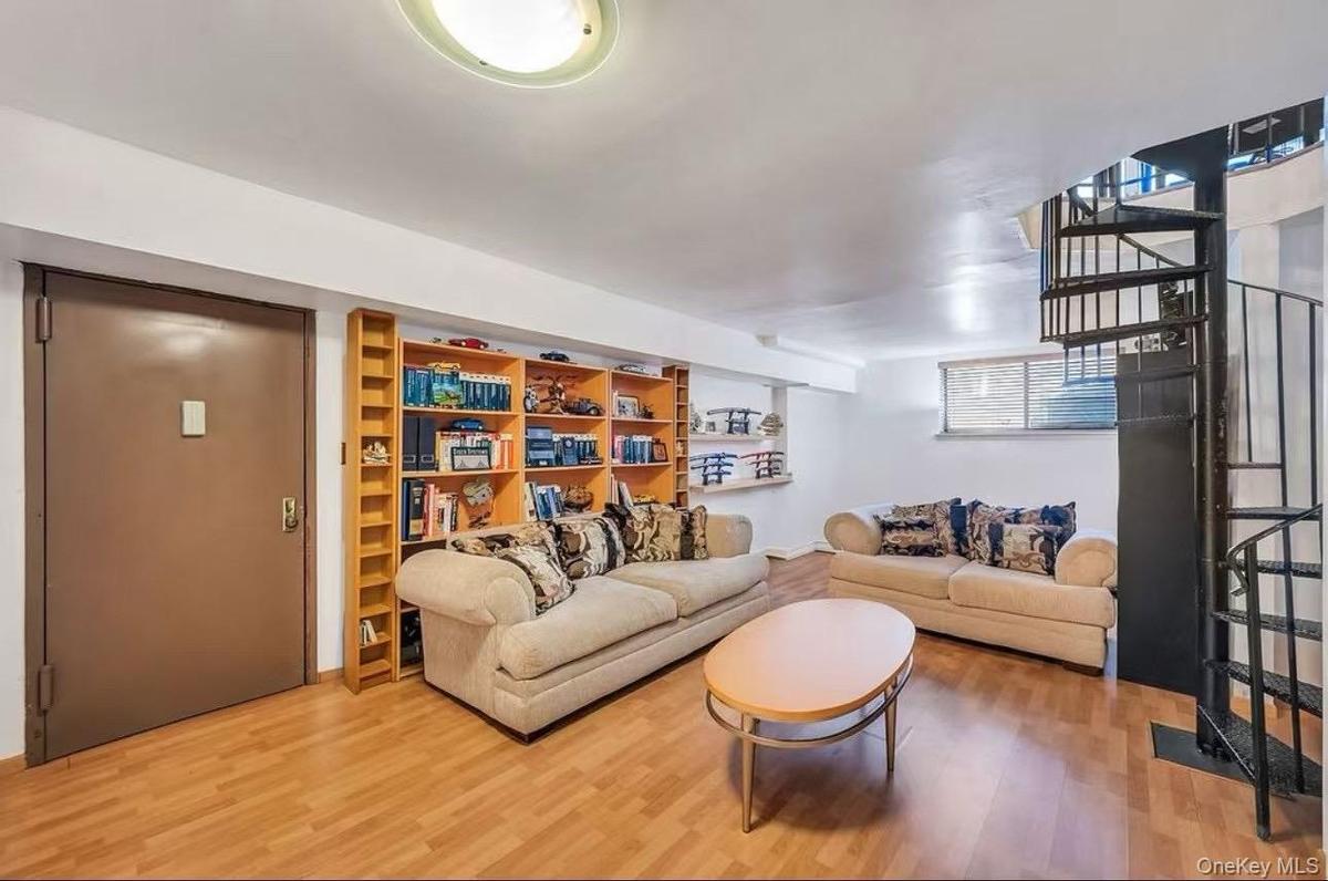 Living room with stairway and wood finished floors
