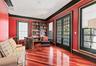 Richly stained wood-finish flooring complements the vibrant walls