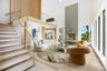 Virtual Staged Living room with a towering ceiling, stairway, a fireplace, and wood finished floors