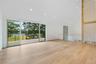 Spare room with recessed lighting, wood finished floors, a water view, and high vaulted ceiling