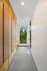 Hallway with finished concrete flooring and recessed lighting