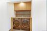 Washroom featuring washer and clothes dryer and cabinet space