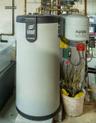 Mechanical room featuring a water heater and an expansion tank