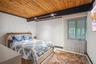 Bedroom featuring baseboards and wooden ceiling