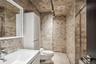 Full bath featuring toilet, tiled shower, vanity, and tile walls