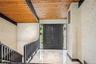Entryway featuring wooden ceiling with exposed beams and marble tiled flooring