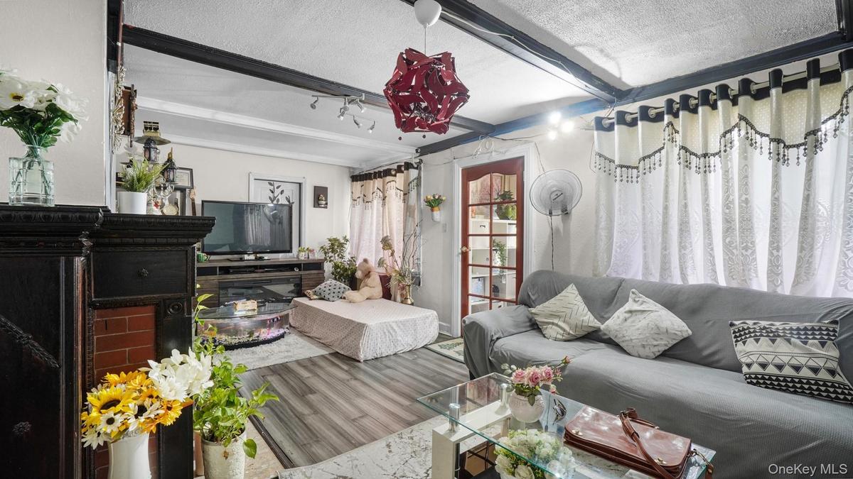 Living room with a textured ceiling and wood finished floors