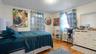 Bedroom with radiator, light wood-style floors, and crown molding
