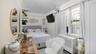 Bedroom featuring radiator heating unit and lofted ceiling
