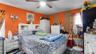 Bedroom with wood finished floors and ceiling fan