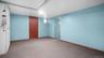 Spare room featuring light carpet and baseboards