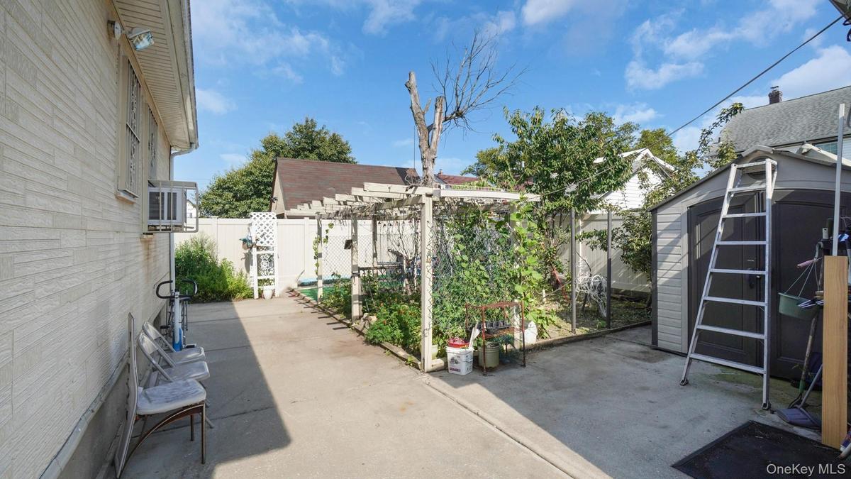 Fenced backyard featuring a patio, a shed, and a pergola