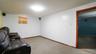 Carpeted living area featuring baseboards