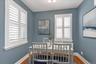 Dining Room featuring multiple windows with white plantation shutters, and hardwood flooring.