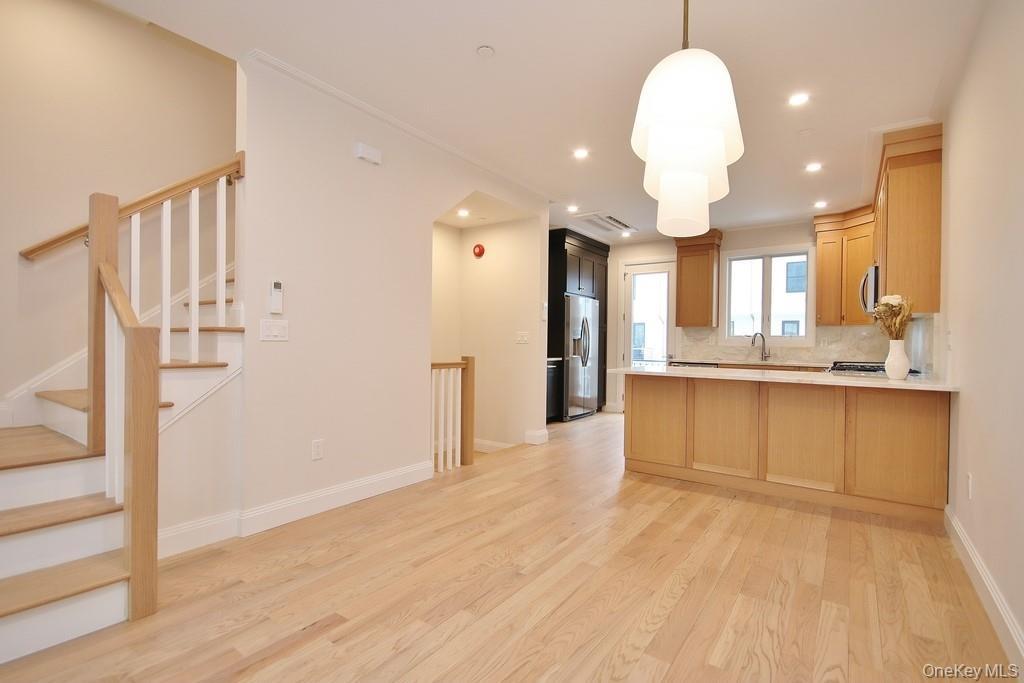 View of Livingroom/dining area and kitchen. Hardwood flooring flows throughout the 2nd, 3rd and 4th floor
