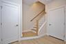 Entry hall with beautiful ceramic tile flooring, 1/2  bath and door out to an oversized one  car garage.