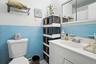 Bathroom featuring tile walls, vanity, a wainscoted wall, and a shower with shower curtain