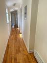 Hall with light wood-type flooring and baseboards