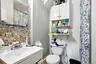 Bathroom featuring tasteful backsplash, vanity, and curtained shower