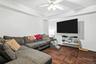 Living area featuring baseboards and a ceiling fan