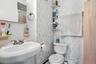 Full bathroom with toilet and curtained shower