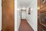 Hall featuring a baseboard heating unit and carpet flooring