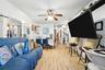 Living area with light wood-style flooring and a ceiling fan