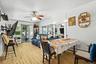 Dining room with light wood finished floors, baseboard heating, and ceiling fan